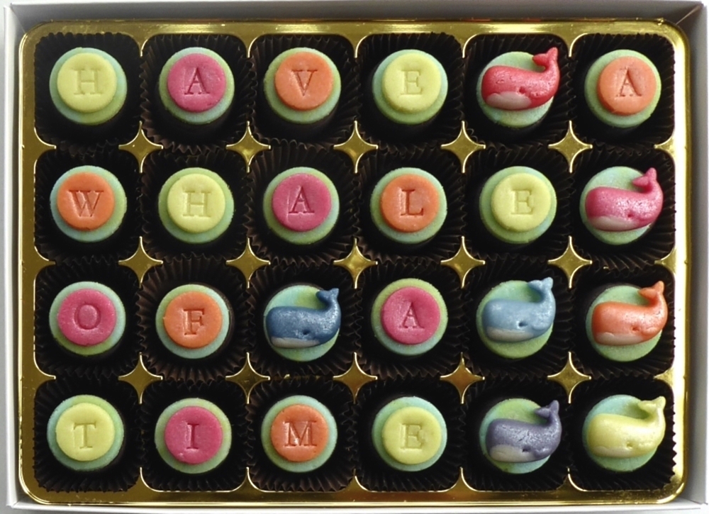 Little whales in rainbow colours decorate chocolates